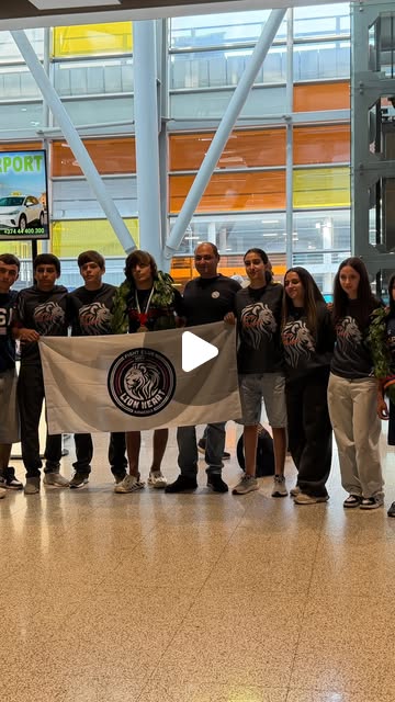 Lion Heart athletes and coaches with the club banner at Zvartnots airport
